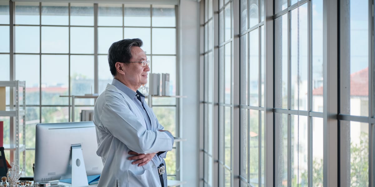Doctor looking outside window